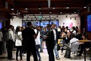 Attendees of the EvolveDigital conference gather in the Montreal Cowork office, on August 4, 2025.