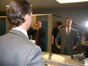 Derick Fage looking in a mirror on the location during filming