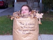 man appears in a bag of leaves