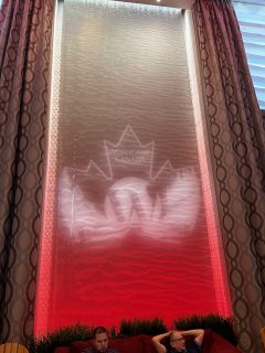 An animated version of the WordCamp Canada logo projected on the wall of the conference centre foyer