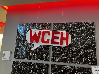 Sign hanging in the shape of a speech bubble that reads “WCEH”, which is short for “WordCamp Eh?”